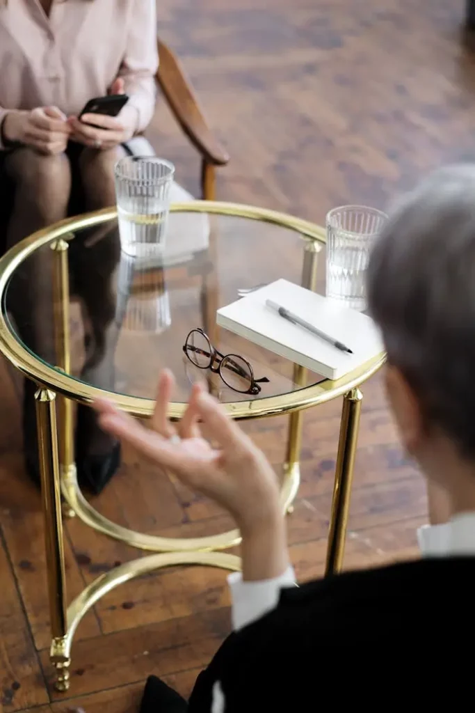 about-Psychiatrist in consultation, notebook on golden table with glass base