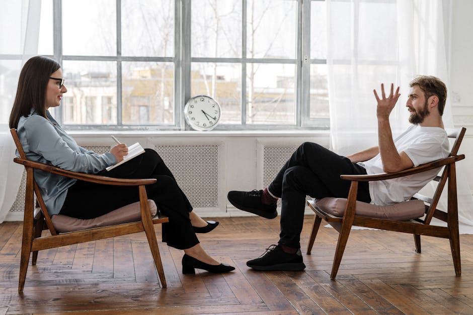 Professional mental health service consultation. A woman and a man in black pants and black shoes sitting on a brown wooden chair