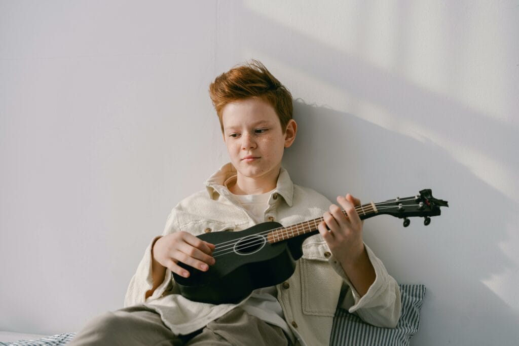 Expressive Therapy for children-Boy holding a Ukulele