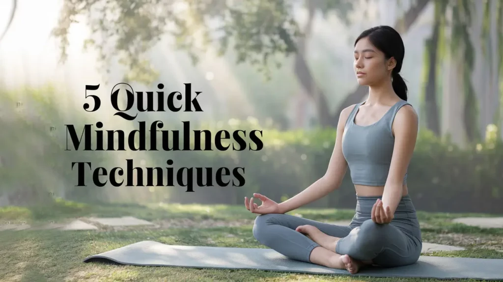 Realistic image of a serene outdoor setting with a young Asian woman sitting cross-legged on a yoga mat, eyes closed and hands resting on her knees in meditation pose. The background shows a peaceful garden with soft, diffused sunlight filtering through the trees. The slight swaying of leaves suggests a gentle breeze. Text superimposed in a soothing font reads “5 quick mindfulness techniques”.